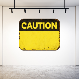 Yellow Caution sign on the white wall of a vanity gallery