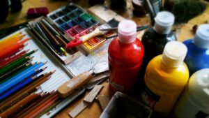 art-supplies-and-paintings-on-a-kitchen-table
