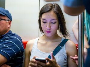 lady-using-her-phone-inside-a-train-in-santiago-metro-photo-by-francisco-osorio