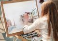 young-woman-painting-outside-focus-point-on-hand-(selective)-city-street-watercolors-left-handed