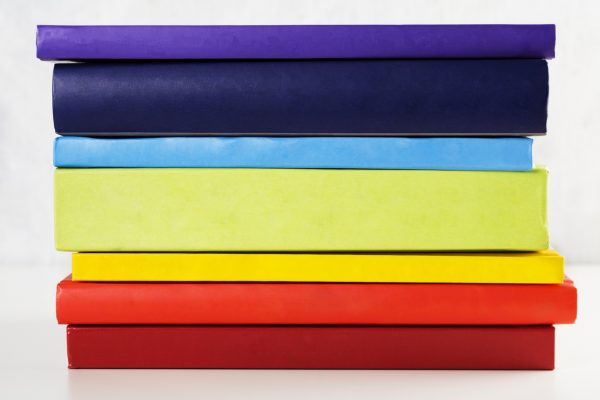 colorful-rainbow-stack-of artist's-books-white-background