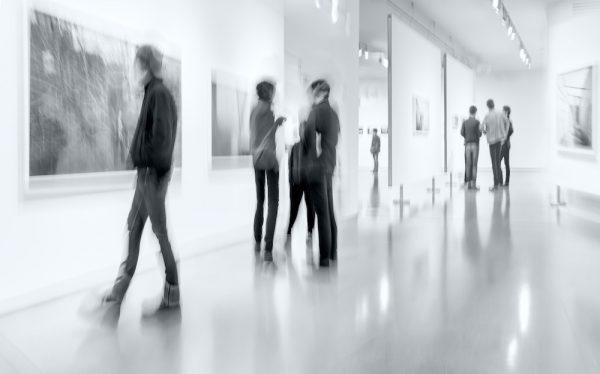 people in the art gallery center in monochrome blue tonality