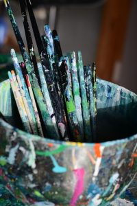 Cropped-shot-of-a-tin-full-of-paintbrushes-in-an-empty-art-studio