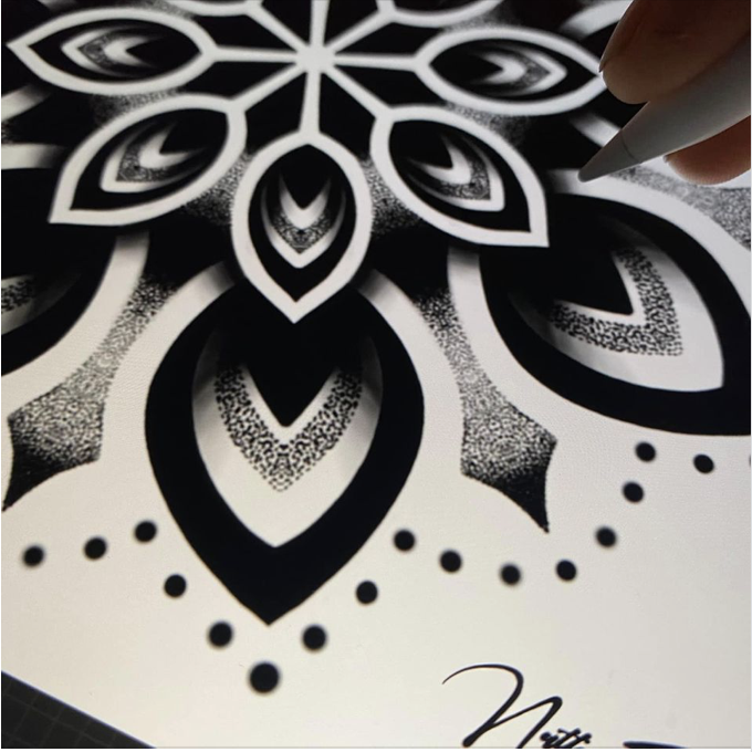 Close-up photo of black and white tattoo design showing off the finer detail