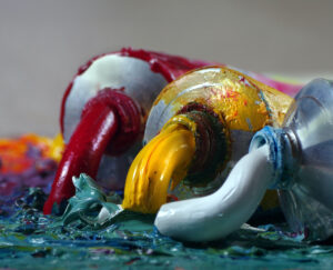 tubes with art oil paint on a palette. colorful art paints close-up