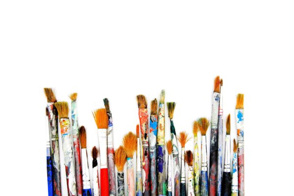 Many colorful paint brush of artist be stained isolated on white