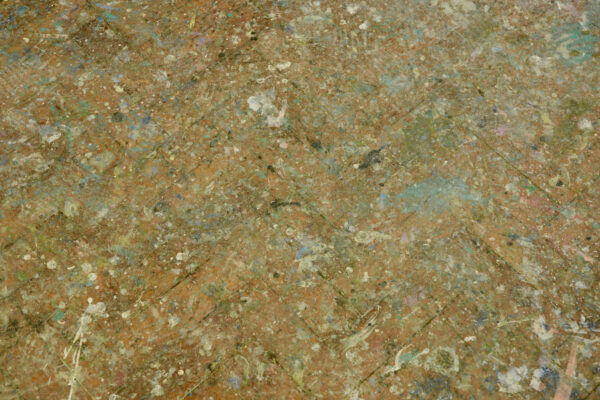 floor of studio with paint splatter looks like a Jackson Pollack painting