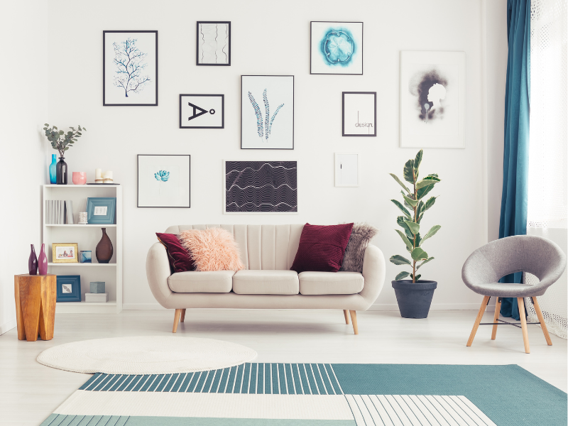modern living room with art wall behind couch, styled bookshelf_Canva