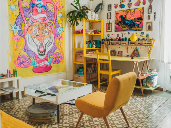 funky yellow art studio with big cat art on the walls