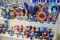 Painted vases and glasses on the counter. Decorated dishes.